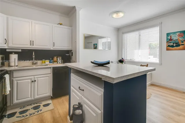 a kitchen with a sink cabinets and appliances
