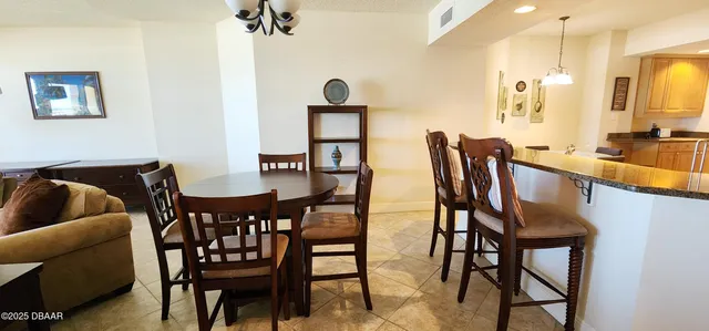 a view of a dining room with furniture and a chandelier