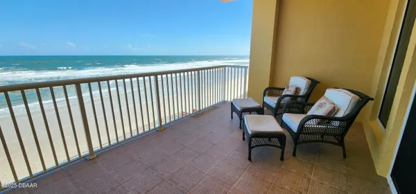 a view of a balcony with furniture