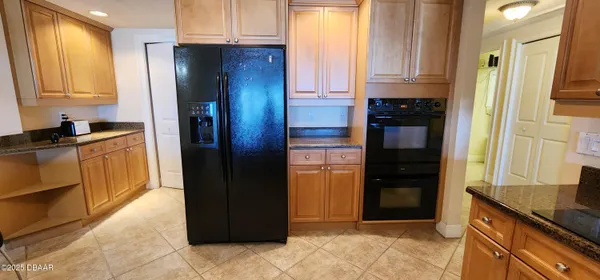 a kitchen with granite countertop a refrigerator and a stove
