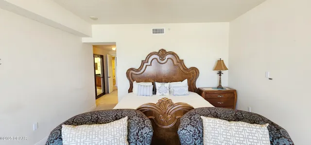 a bedroom with a bed and lamp