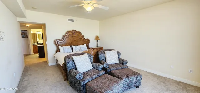 a living room with furniture and a lamp