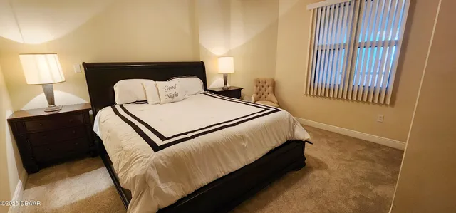 a bed sitting in a bedroom next to a window