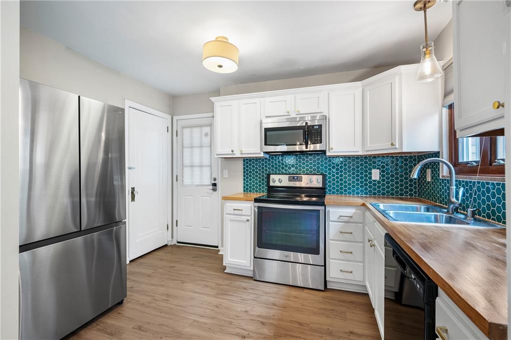 3729 Baytree Street Pittsburgh, PA 15214 - Photo 12 of 30 a kitchen with stainless steel appliances granite countertop a refrigerator stove and sink