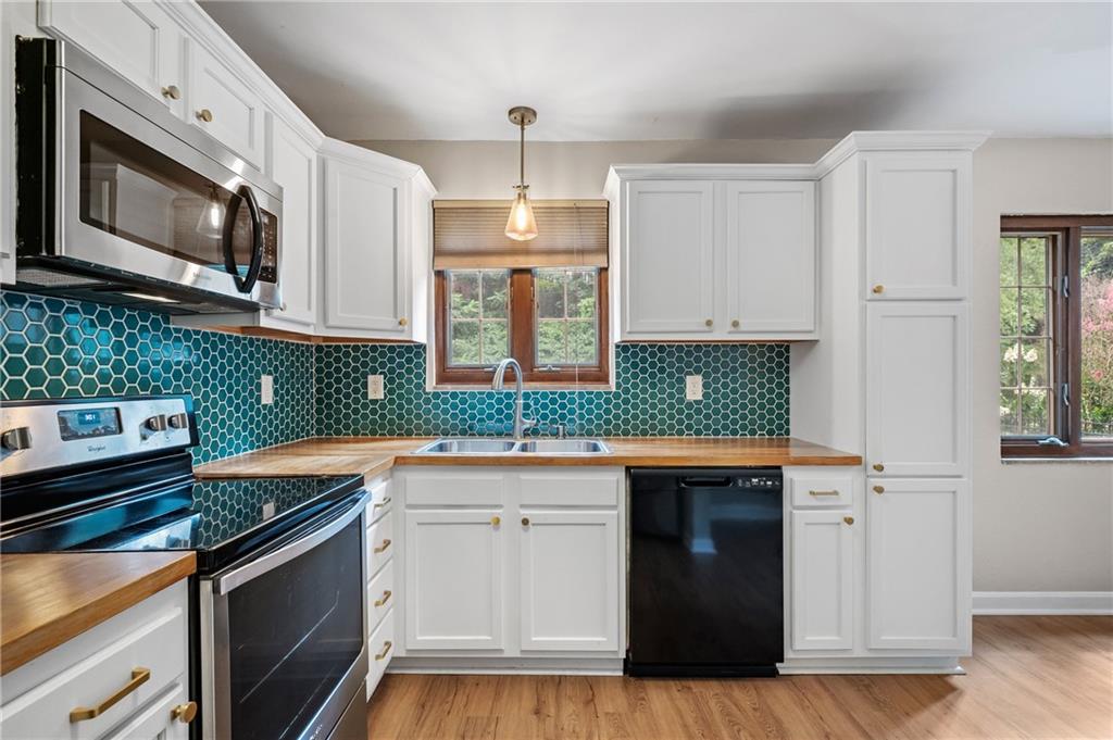 3729 Baytree Street Pittsburgh, PA 15214 - Photo 13 of 30 a kitchen with stainless steel appliances granite countertop a sink stove and microwave