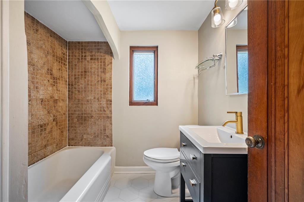 3729 Baytree Street Pittsburgh, PA 15214 - Photo 17 of 30 a bathroom with a sink a toilet and shower