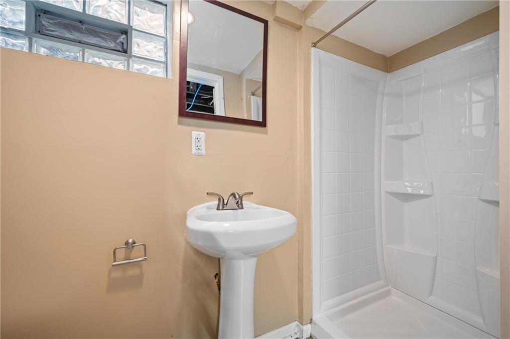 3729 Baytree Street Pittsburgh, PA 15214 - Photo 20 of 30 a bathroom with a sink a mirror and toilet
