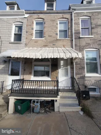 a view of a house with a yard and furniture