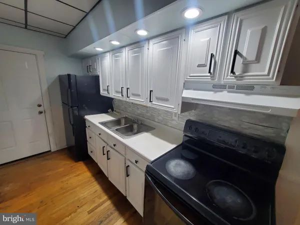 a kitchen with stainless steel appliances granite countertop a stove and a refrigerator