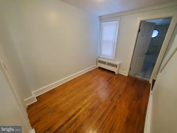 a view of a room with wooden floor and staircase