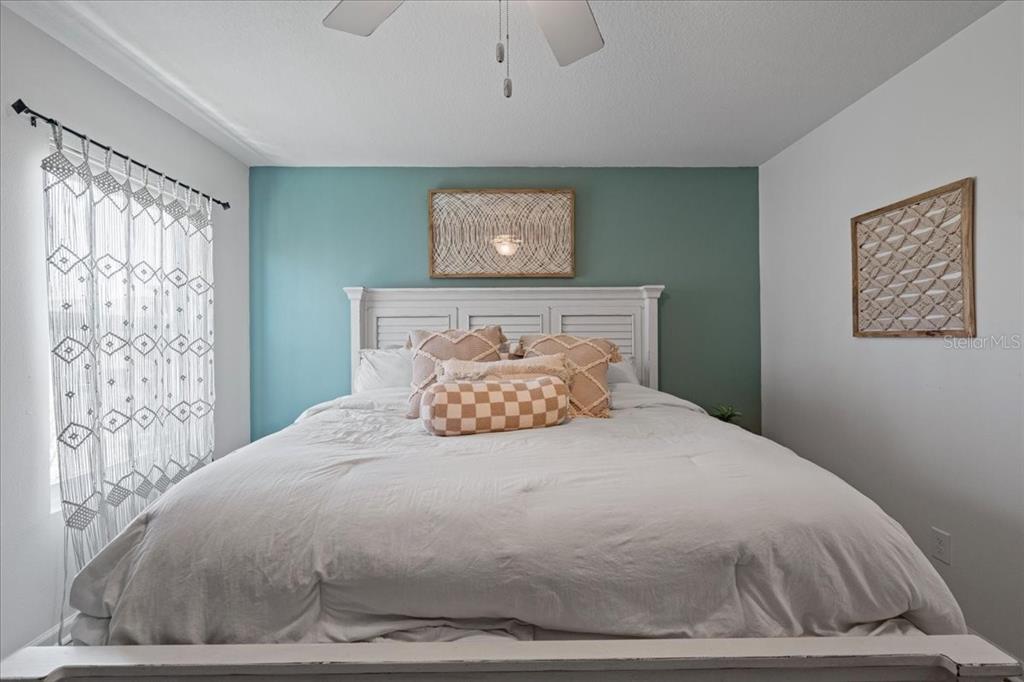 3271 Titanic Circle, Unit 39 Indialantic, FL 32903 - Photo 36 of 60 a large bed sitting in a bedroom next to a window