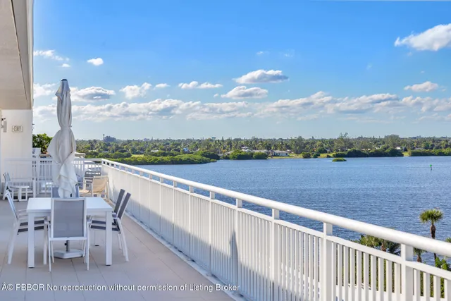 a view of swimming pool with outdoor seating and lake view