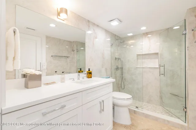 a bedroom with a bed and a flat tv screen on wall