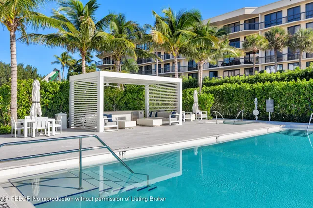 a view of a swimming pool and lounge chairs