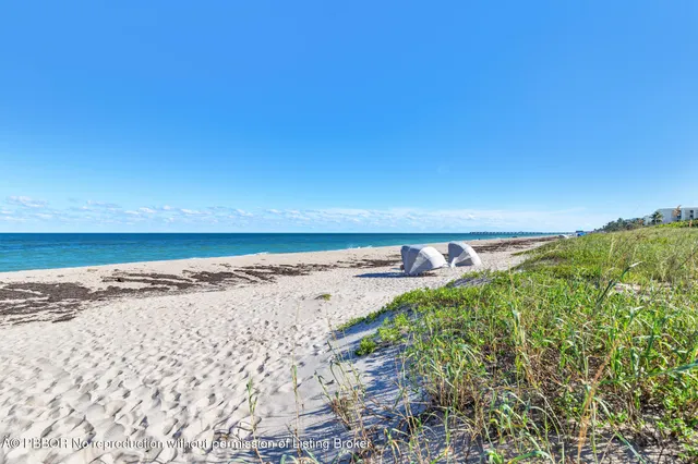 a view of a living room kitchen with stainless steel appliances kitchen island granite countertop a living room