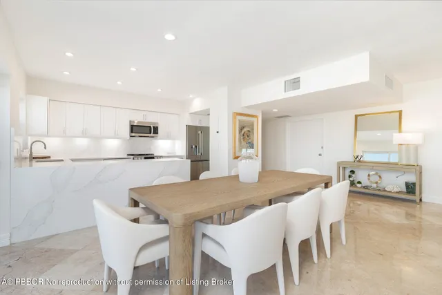 a view of kitchen with granite countertop cabinets table and chairs