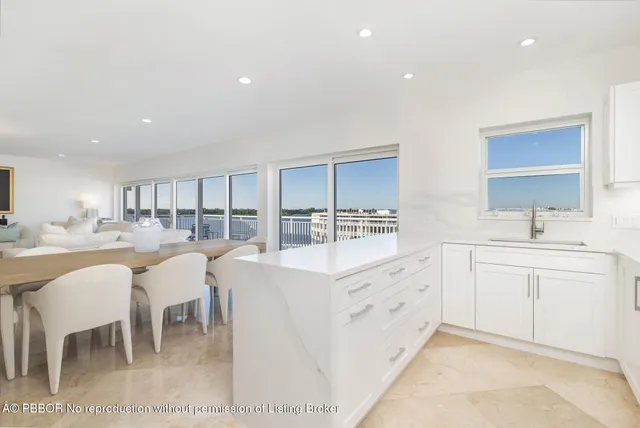 a large white kitchen with lots of counter top space and appliances