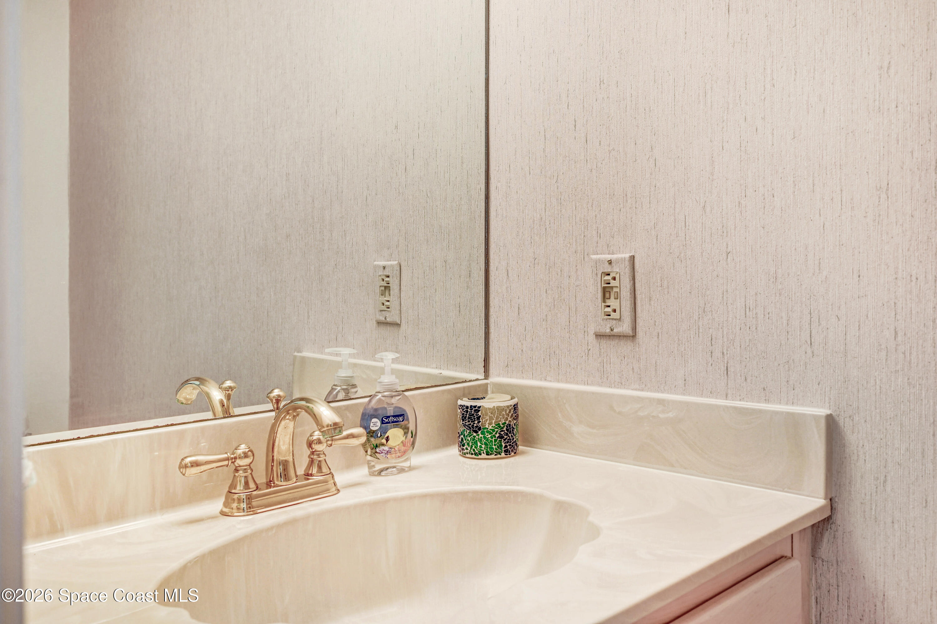 2101 Atlantic Street, Unit 533 Melbourne Beach, FL 32951 - Photo 12 of 51 a bathroom with a sink and a mirror