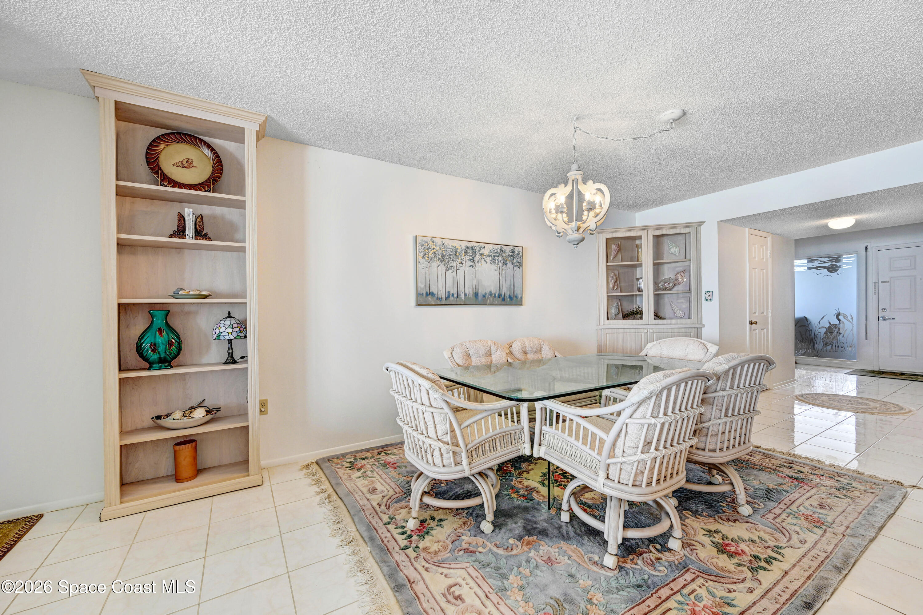 2101 Atlantic Street, Unit 533 Melbourne Beach, FL 32951 - Photo 14 of 51 a view of a dining room with furniture and chandelier