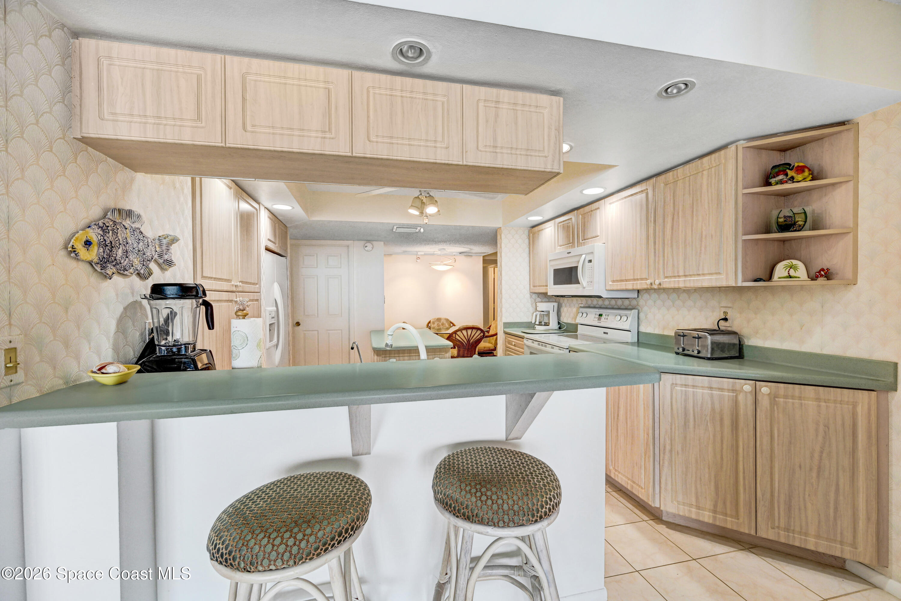 2101 Atlantic Street, Unit 533 Melbourne Beach, FL 32951 - Photo 20 of 51 a kitchen with stainless steel appliances granite countertop a sink and a stove