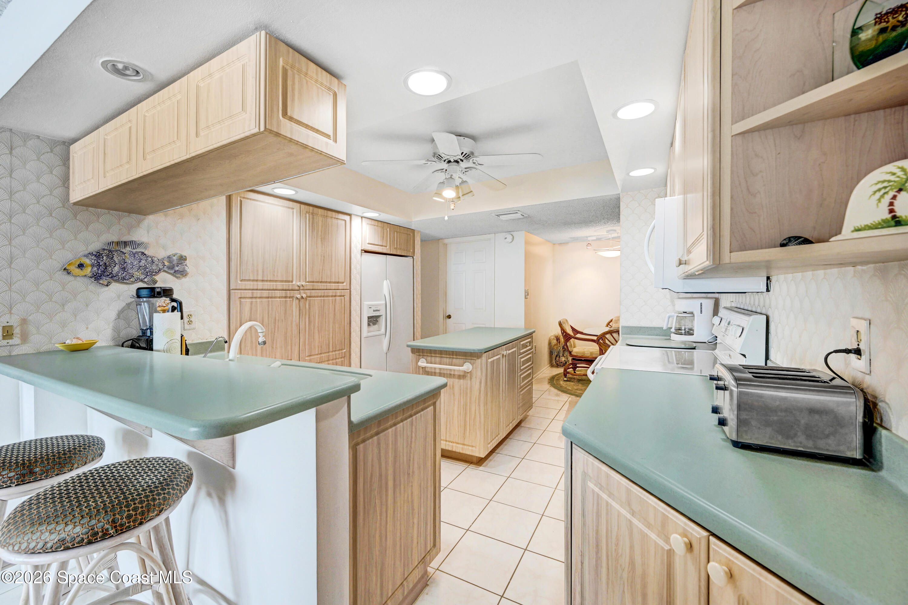 2101 Atlantic Street, Unit 533 Melbourne Beach, FL 32951 - Photo 21 of 51 a kitchen with counter top space a sink and appliances