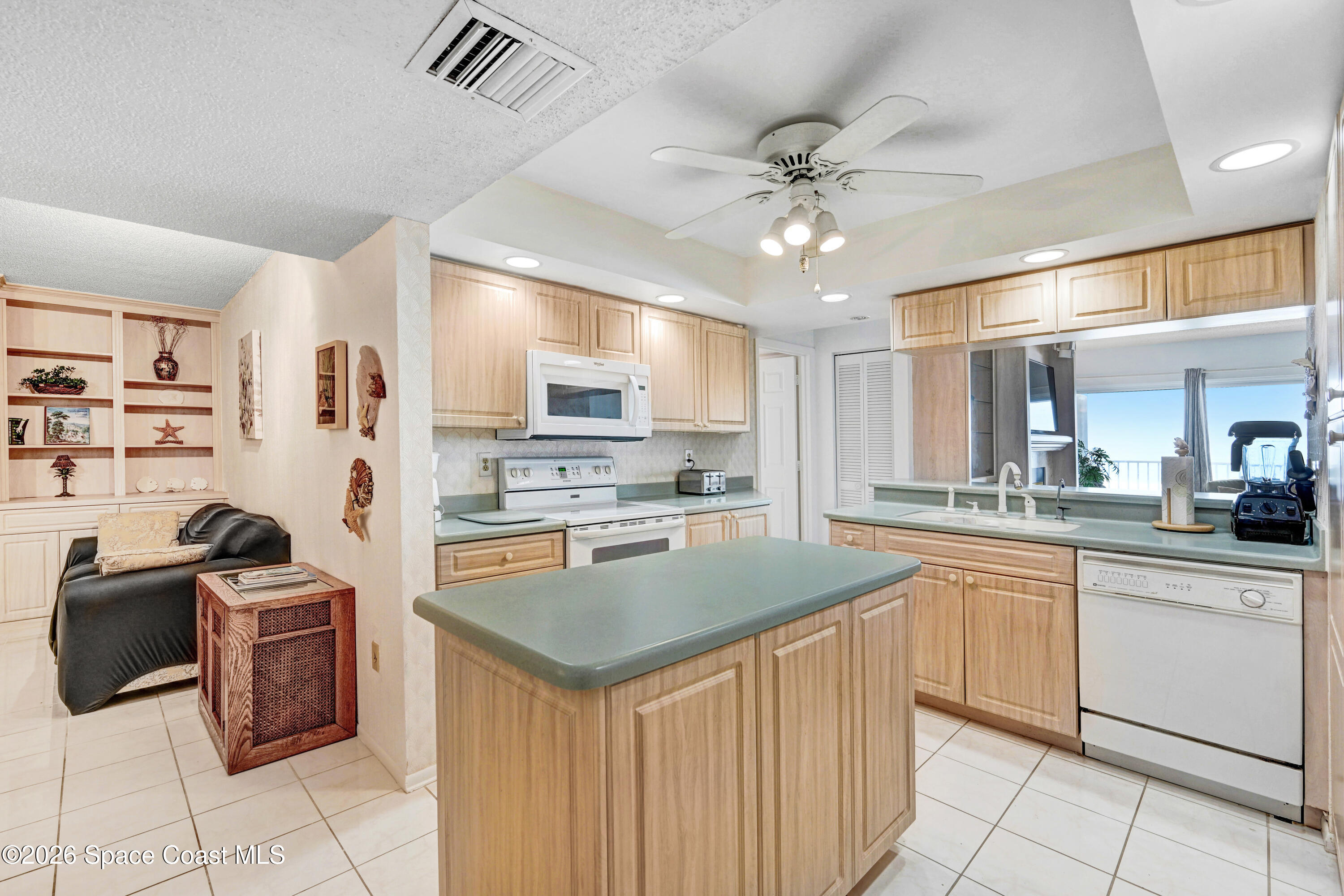 2101 Atlantic Street, Unit 533 Melbourne Beach, FL 32951 - Photo 23 of 51 a kitchen with cabinets a sink and appliances