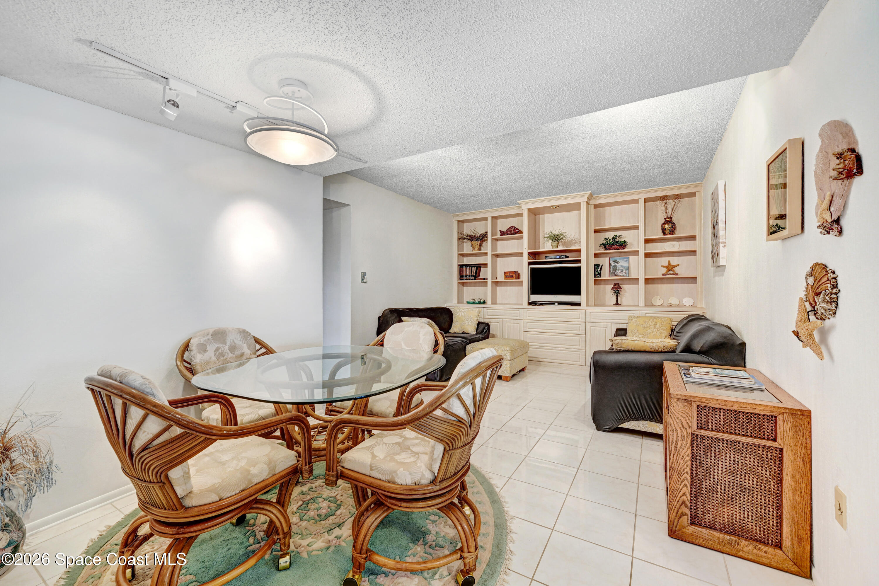 2101 Atlantic Street, Unit 533 Melbourne Beach, FL 32951 - Photo 25 of 51 a dining room with furniture and wooden floor