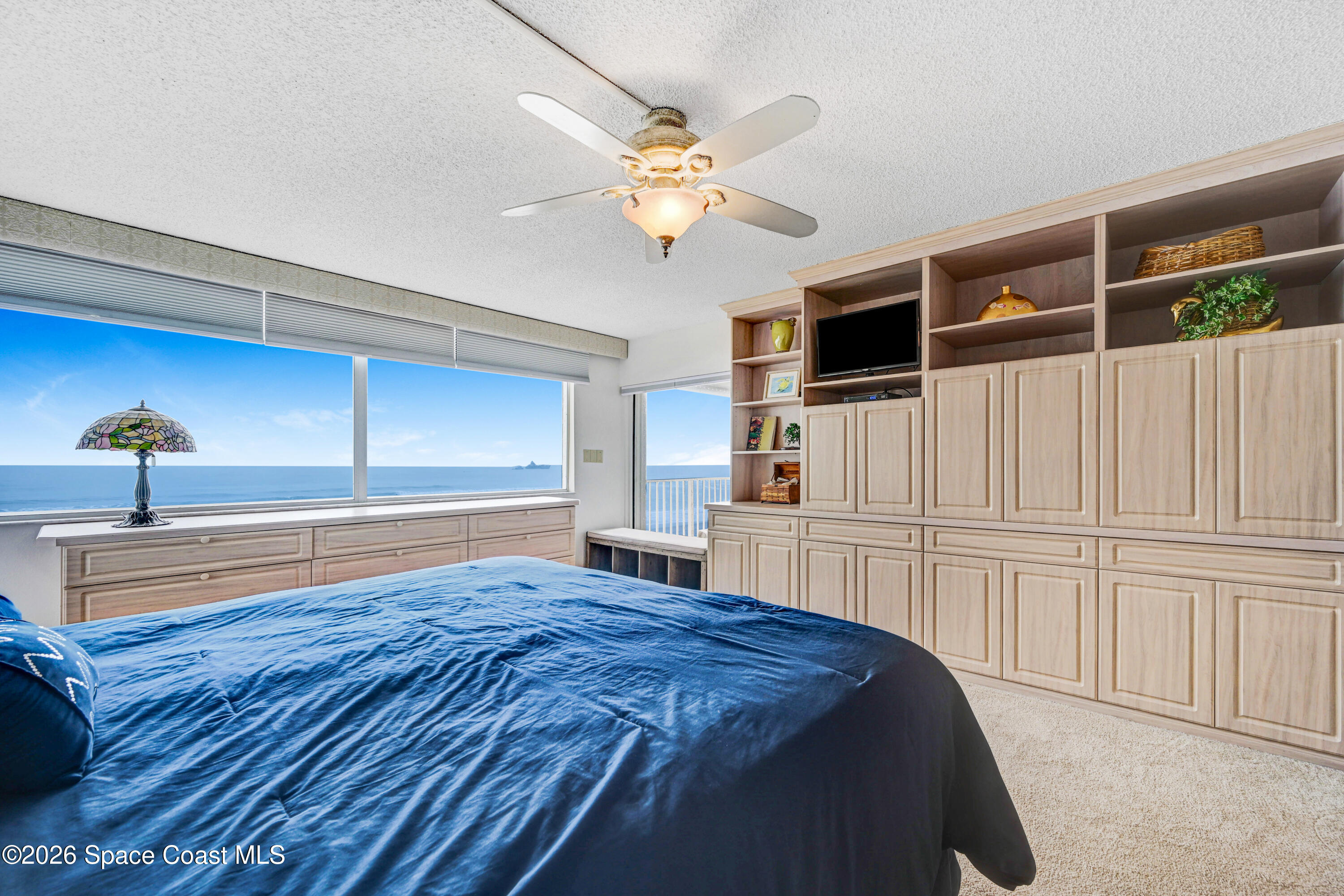 2101 Atlantic Street, Unit 533 Melbourne Beach, FL 32951 - Photo 29 of 51 a spacious bedroom with a bed and a flat screen tv