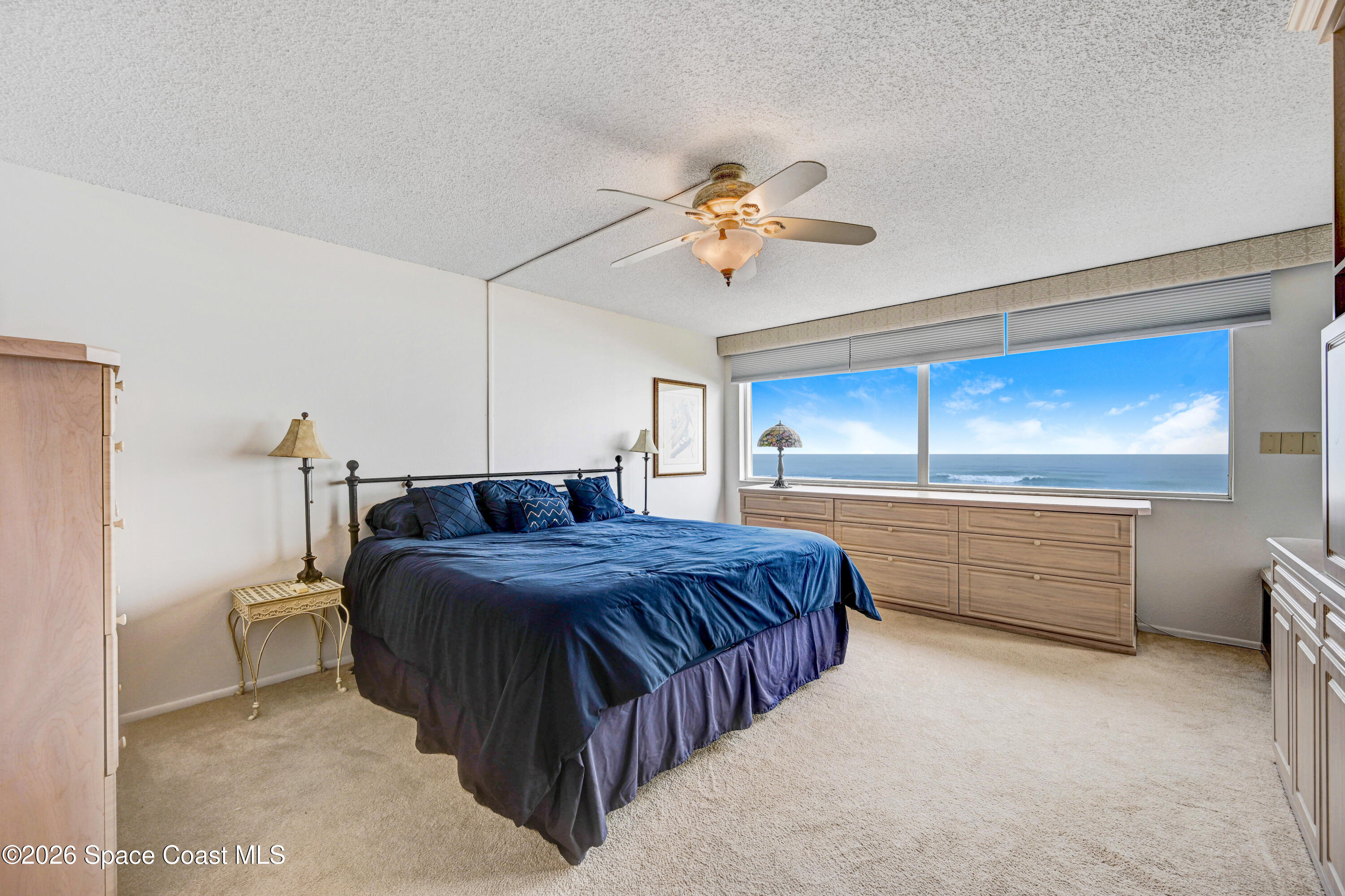 2101 Atlantic Street, Unit 533 Melbourne Beach, FL 32951 - Photo 30 of 51 a bedroom with a bed and a chandelier