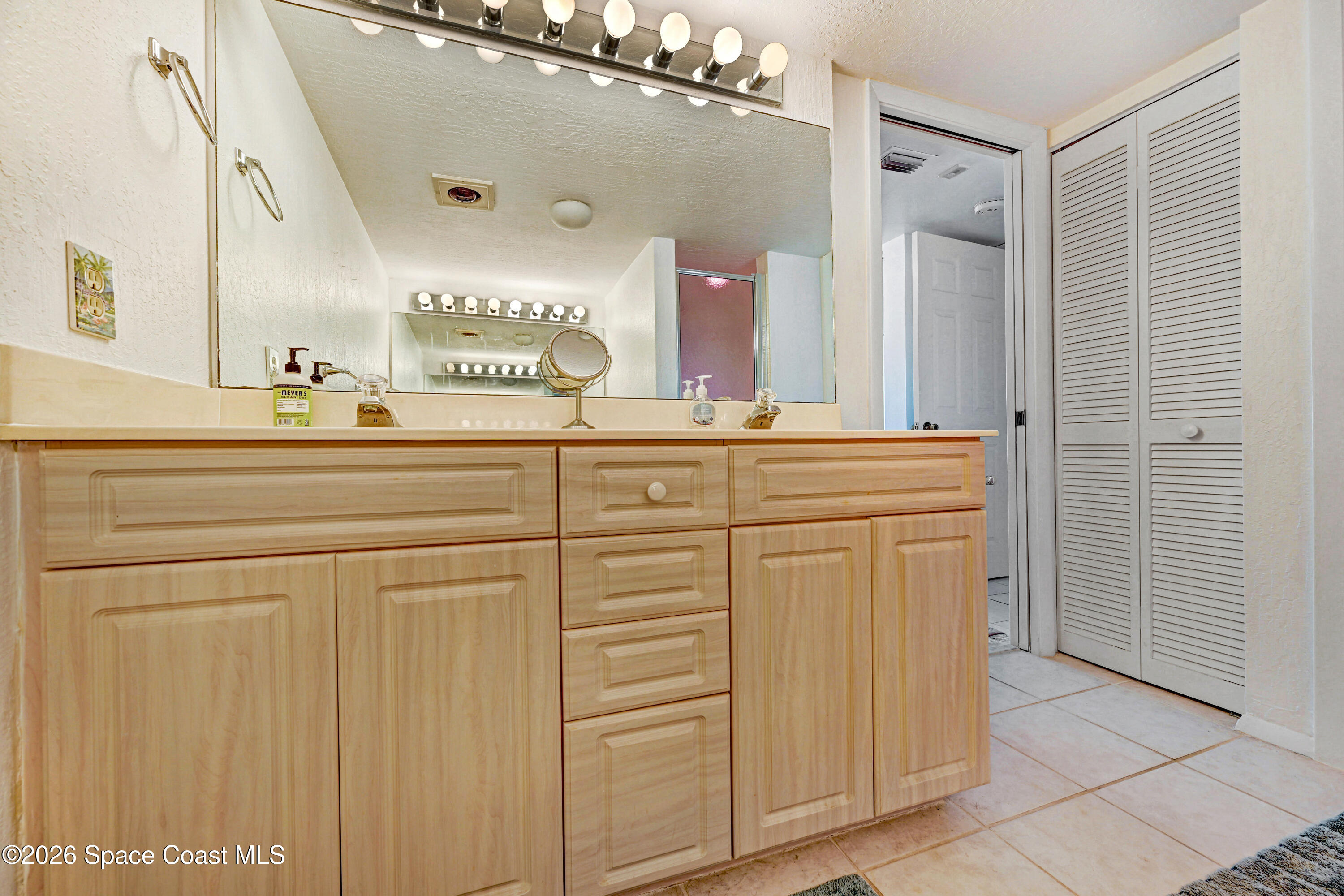 2101 Atlantic Street, Unit 533 Melbourne Beach, FL 32951 - Photo 35 of 51 a spacious bathroom with a sink a vanity and a mirror