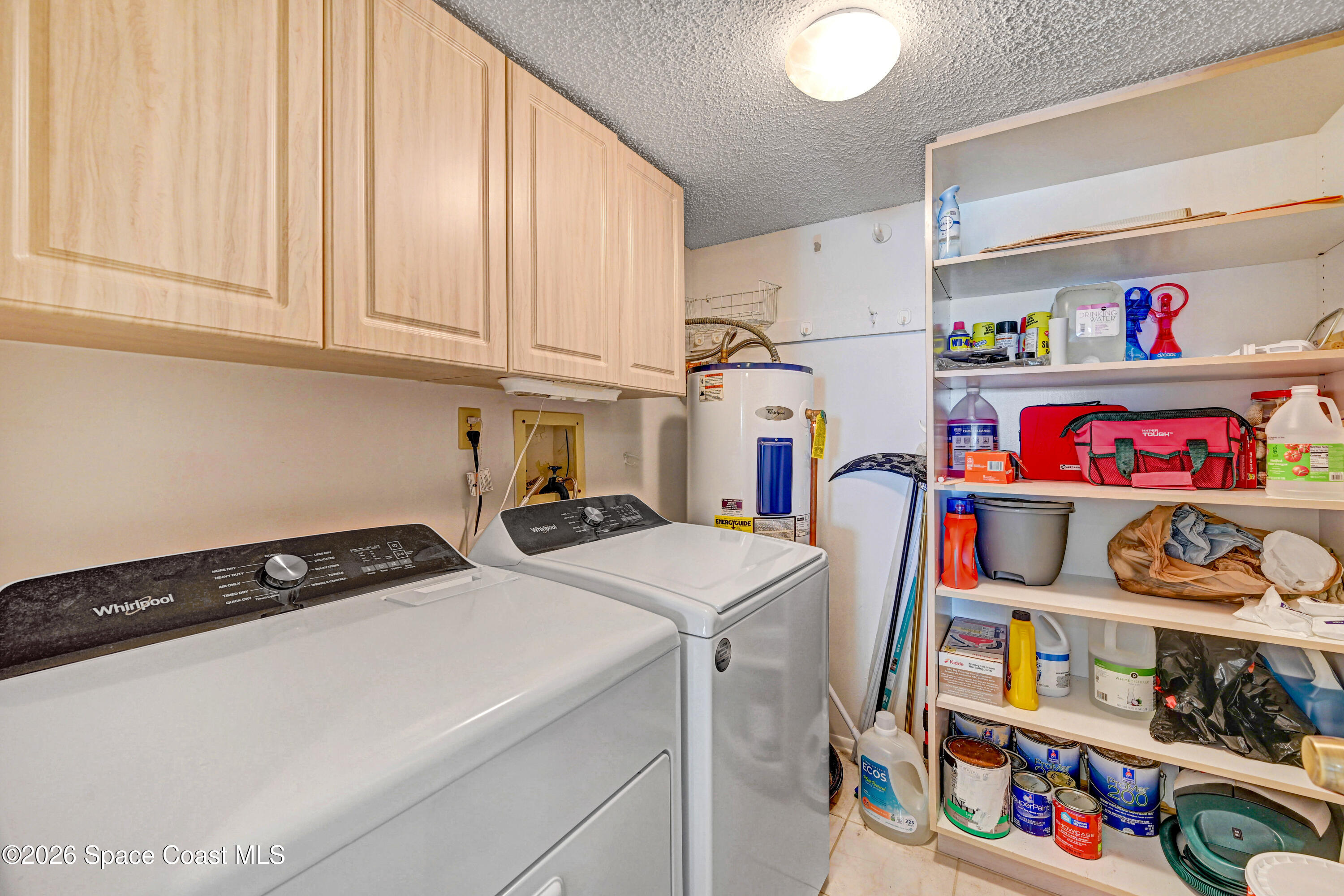 2101 Atlantic Street, Unit 533 Melbourne Beach, FL 32951 - Photo 37 of 51 a utility room with fridge dryer and washer