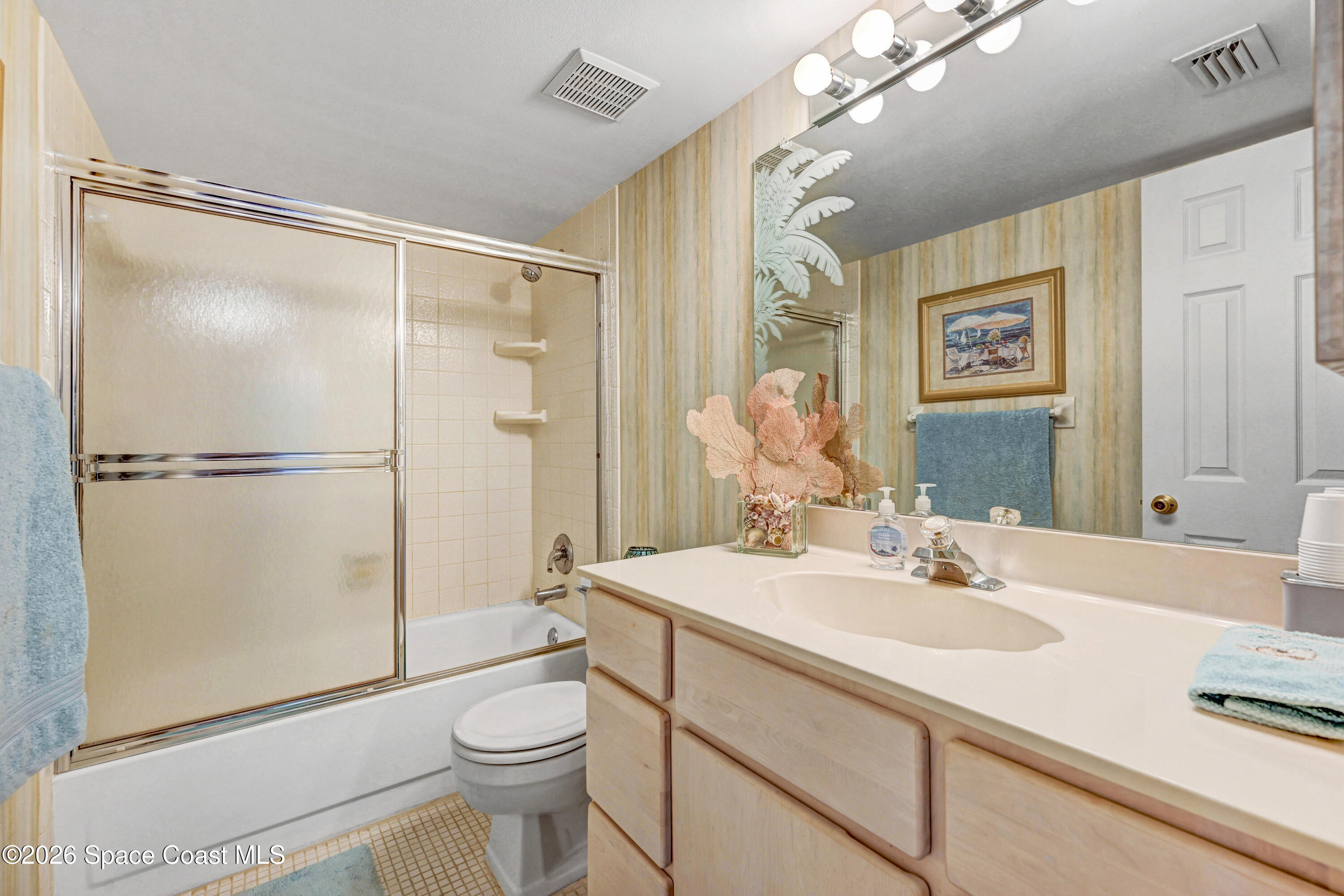 2101 Atlantic Street, Unit 533 Melbourne Beach, FL 32951 - Photo 38 of 51 a bathroom with a sink a toilet a mirror and shower