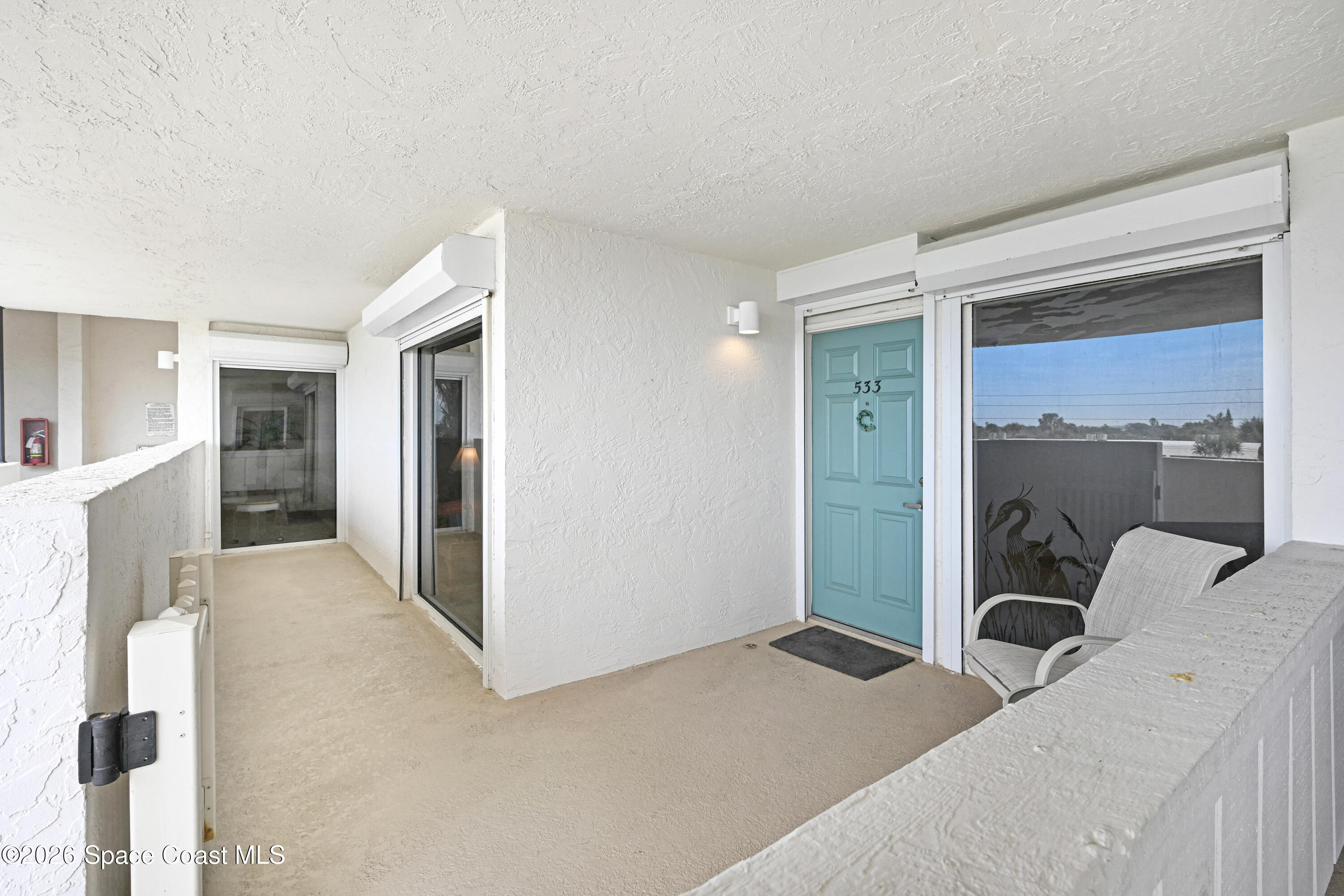 2101 Atlantic Street, Unit 533 Melbourne Beach, FL 32951 - Photo 7 of 51 a bedroom with a bed and a large mirror