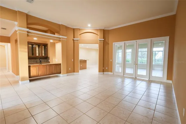 a view of an empty room with a fireplace and a large window