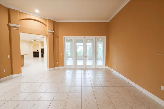 a view of an empty room with glass door