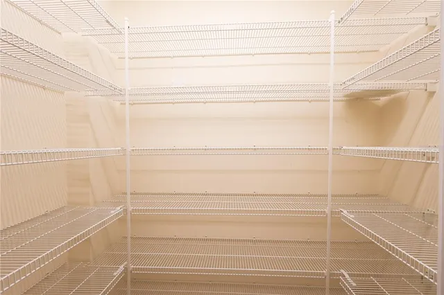 a bedroom with a bed a flat screen tv and a couch