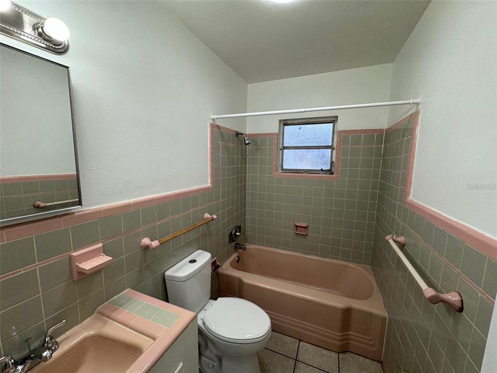 4023 Southwest 20th Street Gainesville, FL 32608 - Photo 9 of 10 a bathroom with a toilet a sink and bathtub