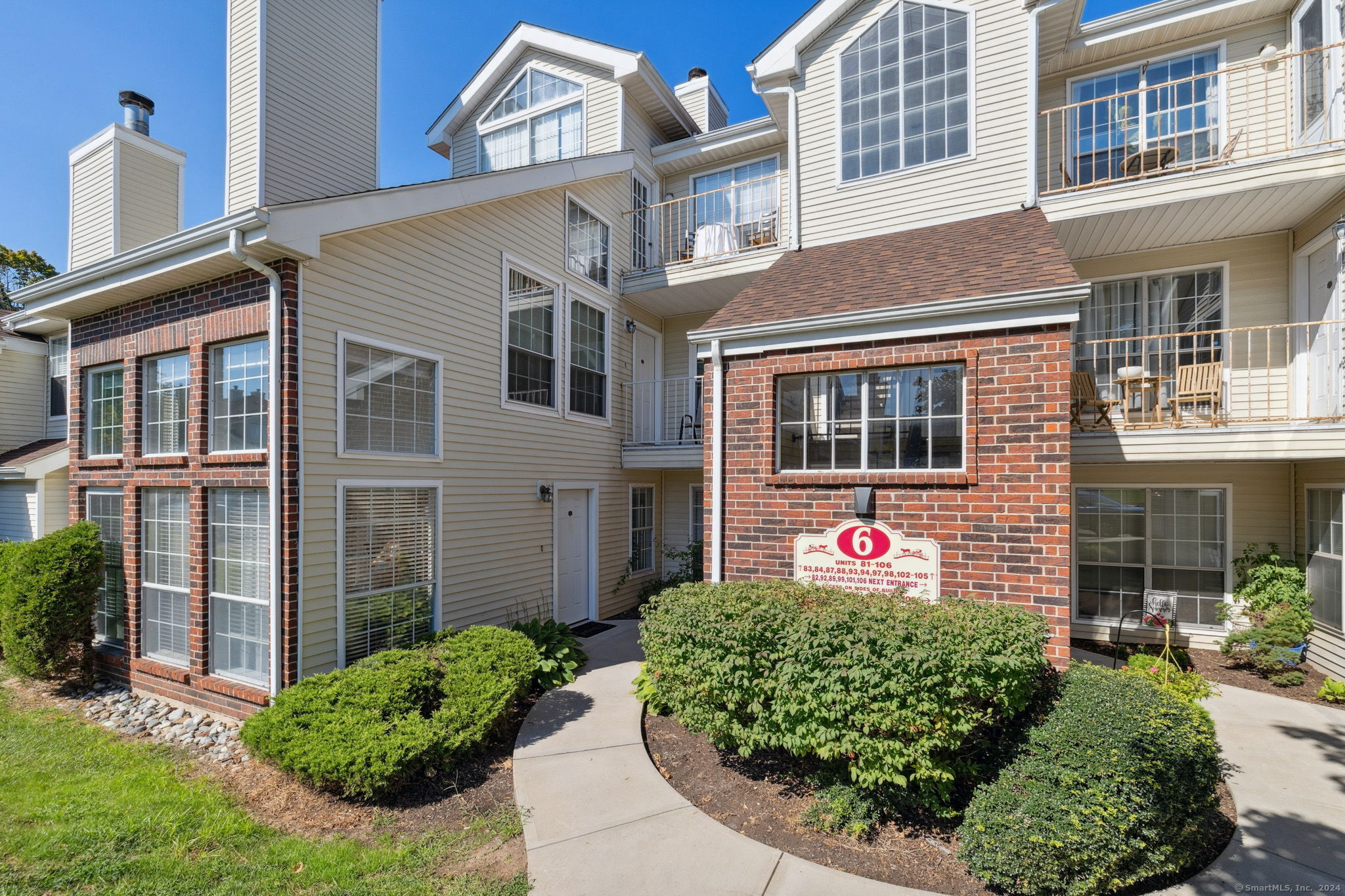 84 Carriage Crossing Lane, Unit 84 Middletown, CT 06457 - Photo 1 of 1 a front view of a house with a yard and outdoor seating