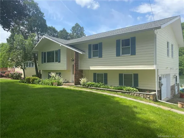 a front view of house with yard and green space