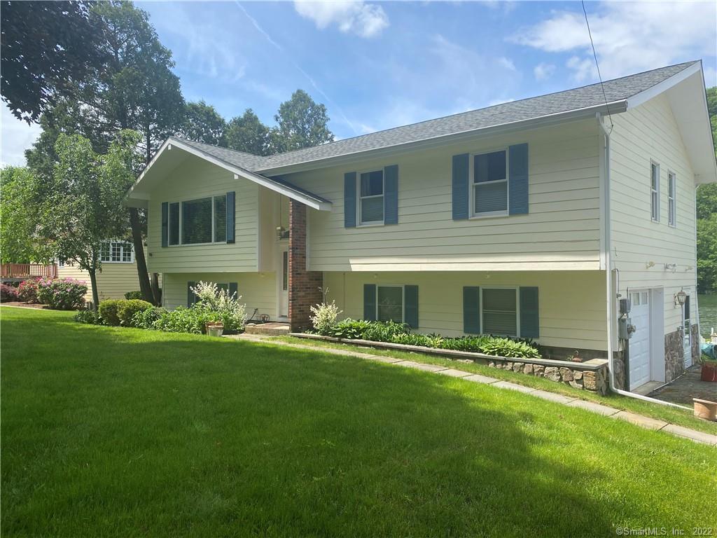 a front view of house with yard and green space