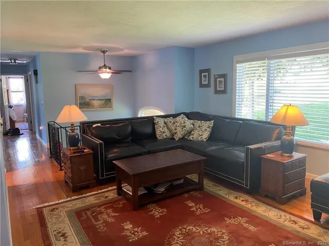 a living room with furniture a lamp and a window