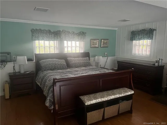 a bedroom with a bed and window
