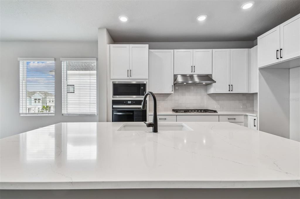 1631 Springwell Lane Sarasota, FL 34240 - Photo 12 of 43 a kitchen with stainless steel appliances granite countertop a refrigerator a stove and a sink
