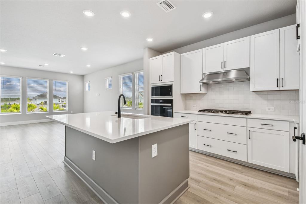 1631 Springwell Lane Sarasota, FL 34240 - Photo 13 of 43 a kitchen with stainless steel appliances granite countertop a sink stove and refrigerator