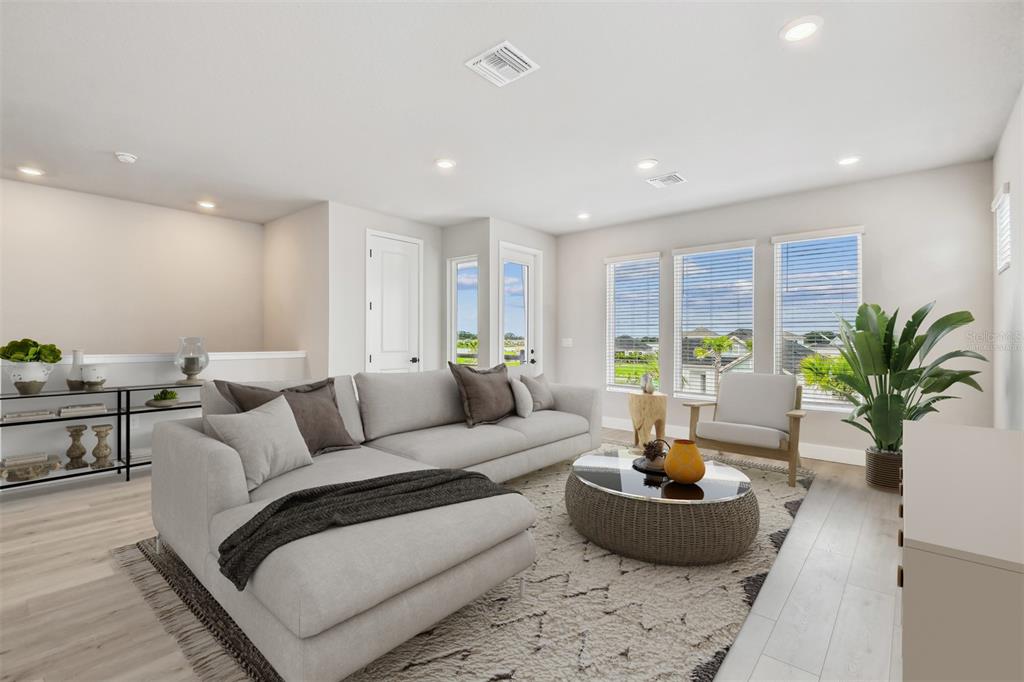 1631 Springwell Lane Sarasota, FL 34240 - Photo 16 of 43 a living room with furniture and a potted plant