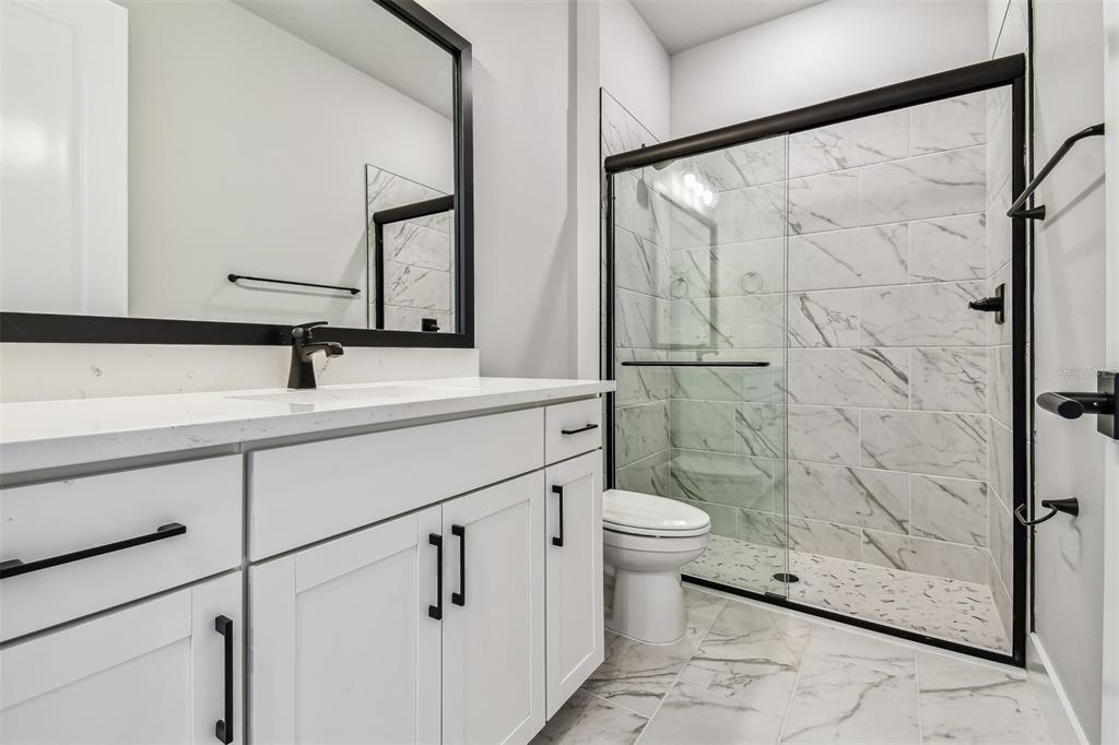 1631 Springwell Lane Sarasota, FL 34240 - Photo 32 of 43 a bathroom with a sink and a mirror