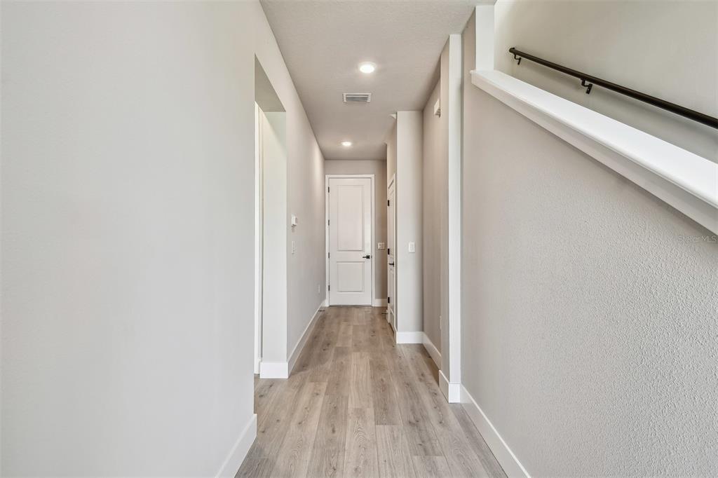 1631 Springwell Lane Sarasota, FL 34240 - Photo 6 of 43 a view of a hallway with wooden floor