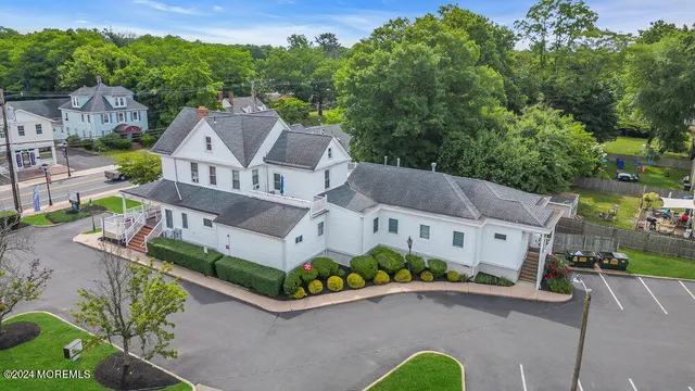 an aerial view of a house with a garden and street view