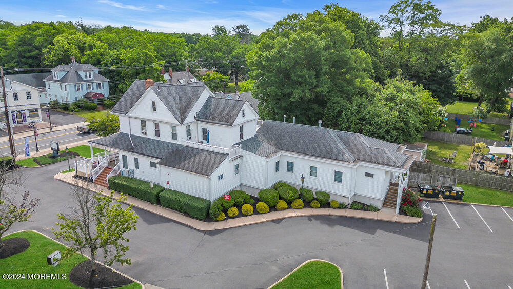 an aerial view of a house with a garden and street view