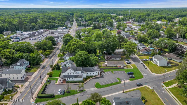 an aerial view of residential houses with outdoor space and swimming pool